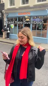 A promotional video featuring a creator announcing a free giveaway at SushiDog. The video includes shots of the shop exterior, the sushi rolls, and the creator eating the product, with text overlays detailing the date, time, and quantity of the giveaway.