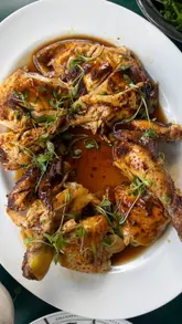 A short, punchy video showcasing a rotisserie chicken meal at Panzer's Deli in London, featuring close-ups of the food and a brief look at the venue.