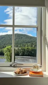 A montage showcasing a stay at the Atholl Arms Hotel in Dunkeld, highlighting the room interiors, river views, and dining options.