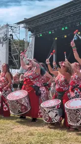 A recap video of the Africa Oyé festival in Sefton Park, Liverpool. The video features live drumming performances, crowd shots, a henna artist, various market stalls selling jewelry and accessories, and street food including a jerk chicken wrap and fried dough.
