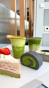 A short, polished montage featuring various matcha-based drinks and desserts at Tsujiri, including a matcha latte, tiramisu, crepe cake, and cheesecake.