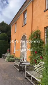 A montage video showcasing the exterior, interior, and garden of Langar Hall, featuring a guest enjoying the atmosphere and a drink.