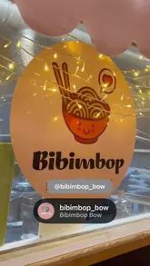A short video showcasing a Korean fusion takeaway spot called Bibimbop Bow, featuring shots of the exterior, menu, and various food items like bao, rice bowls, gyoza, and a mocktail.