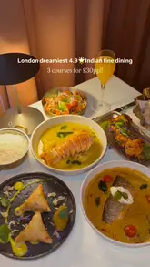 A high-quality promotional video for Vatavaran, an Indian fine dining restaurant in London. The video features a variety of dishes including lobster curry, pan-seared fish, and samosas, alongside shots of the restaurant's elegant interior and bar area.