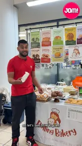 Two presenters review the Korean cream cheese garlic bun from Rolling Bakery at a pop-up event in a shopping centre, sharing their reactions to the texture and flavor.