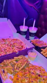 A short, energetic montage showcasing the interior and menu of Crown The Chaos Kitchen in Bradford. The video highlights the venue's vibrant, comic-book-inspired decor, including neon signs and murals, alongside close-ups of pizzas, loaded fries, milkshakes, and burgers.