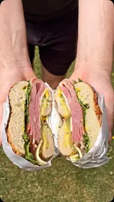 A short promotional video for 'Junto by Poached' in Beckenham, featuring close-ups of a pastrami bagel, the shop's exterior, interior decor, and coffee offerings.