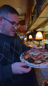 A creator reviews Bosco Pizzeria in Bristol, showcasing two Neapolitan-style pizzas and sharing his enthusiastic opinion on the quality of the dough and ingredients.