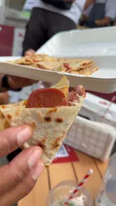 A fast-paced street food review featuring a Turkish gözleme stall. The video captures the entire process from dough rolling and filling to the final product being served and enjoyed by customers.