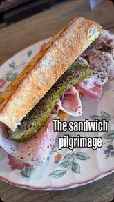 A creator documents their journey to a sandwich shop in Brixton, highlighting the preparation of a jambon beurre baguette and sharing their enthusiastic reaction to the food.