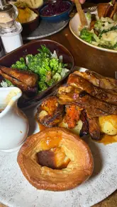 A video showcasing a Sunday lunch experience at The Badger in Ponteland, featuring shots of the exterior, interior, menu, and various dishes including starters and a Sunday roast.