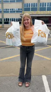 A creator and her mother visit the Fox's Biscuit Outlet in Batley, showcasing the variety of discounted biscuits, cookies, and merchandise available. The video highlights the affordability of the items and the shopping experience.