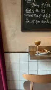 A visually appealing, aesthetic showcase of dishes and drinks at Belly, a neighbourhood bistro in Kentish Town, featuring items like tempura cod pandesal, ceviche, and desserts.