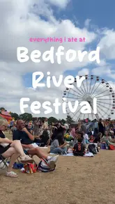 A vlog-style reel documenting a visit to the Bedford River Festival, highlighting various food vendors including Cibo's Italian Subs, George's Gelato by Lou's, Patisserie Sheree, and Mala Dragon. The creator samples a variety of items, from savoury rolls and noodles to sweet treats like gelato-stuffed donuts and brownies.