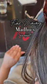 A montage video showcasing the interior and various dishes at Madhu's restaurant, featuring close-ups of Indian-Kenyan fusion cuisine.