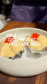 A professional recipe tutorial demonstrating the preparation of oysters topped with a grapefruit hollandaise sauce, trout roe, and fresh fennel. The video features clear, close-up shots of the cooking process and the final plating.