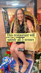 A vlog-style review of Spice Bloom in Liverpool, highlighting the restaurant's sensory experience, floral decor, and Indian cuisine.