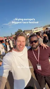 A high-energy vlog featuring two creators exploring 'The Tacover' festival in London, sampling various tacos, churros, and drinks while showcasing the festival's atmosphere, including live music and Lucha Libre wrestling.