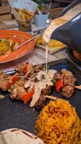 A promotional reel for Manjaros in Leicester, featuring a tour of the interior, the creator, and a variety of dishes including lamb skewers, chicken parmesan, and mojitos.
