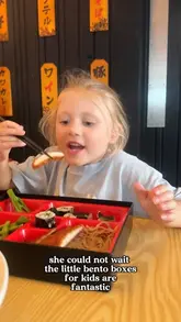 A candid, family-oriented shot of a child enjoying a bento box at a restaurant, captured during a day out in Southampton.