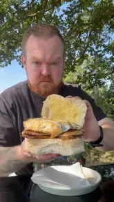 A vlog-style video showcasing a visit to 'Route 41', a countryside cafe operating out of a barn and horsebox. The video highlights the outdoor seating, the breakfast baps, coffee, and the relaxed, family-friendly atmosphere.
