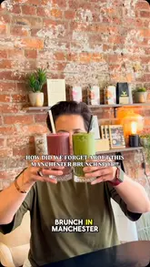 A bright, casual shot of two drinks being held up in front of a brick wall, typical of a brunch review video.