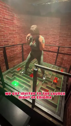 Group of friends enjoying cocktails and arcade games after an escape room adventure, celebrating a fun night out.