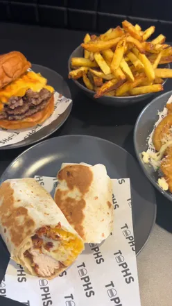 Couple enjoying comfort food at Tophs, newly opened eatery in Bellshill, from the owners of Tophs and Lunch Glasgow.