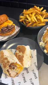 Couple enjoying comfort food at Tophs, newly opened eatery in Bellshill, from the owners of Tophs and Lunch Glasgow.