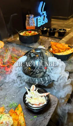 Diverse dishes at Blac, Stratford Road, showcasing a stylish dining experience with mocktails and beautifully presented food.