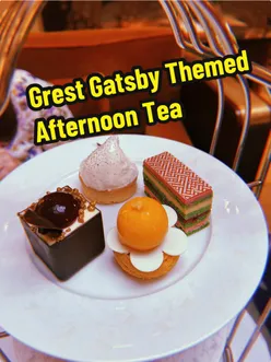 Guests enjoying a luxurious Great Gatsby Afternoon Tea at Sheraton Grand London Park Lane with themed cakes and sandwiches.
