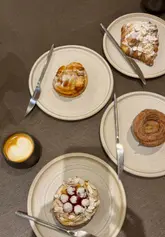 Enjoying pastries and coffee at Saint Hugo Bakery in Swansea, the perfect morning spot for food lovers.