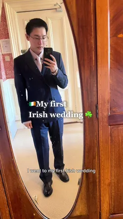 Chinese man enjoying an Irish wedding celebration, showcasing cultural blend and lively atmosphere.