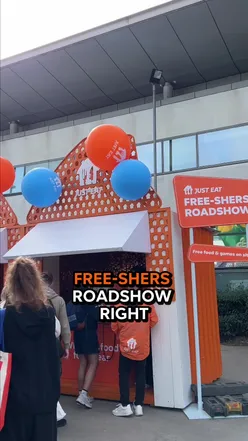 Students enjoying pizza and games at UCD's Free-shers Roadshow, featuring @firedupizza’s delicious slices. 🍕🔥 #JustEat