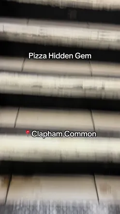 Food blogger enjoying pizza at Joe Public Pizza in Clapham, London; vibrant atmosphere and delicious flavors.