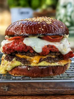 Delicious burger and pizza fusion meal, perfect for food lovers at home. Mouthwatering flavors coming together!