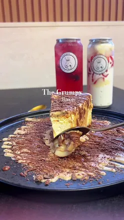 Delicious cheesecake slice at The Grumpy Baker, showcasing dessert delights in Manchester and Bradford.