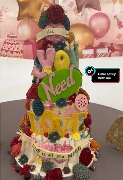 Five-tier love-themed cake with chocolate flowers and hearts, showcasing stunning edible treats for a special event.