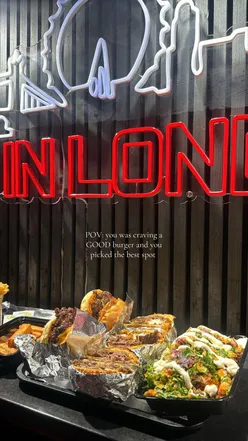 Delicious beef burger with loaded fries at a popular London eatery, inviting return visits for more tasty meals.