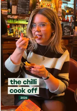 Friends enjoying chili dishes and tequila at a lively cook-off in Edinburgh.