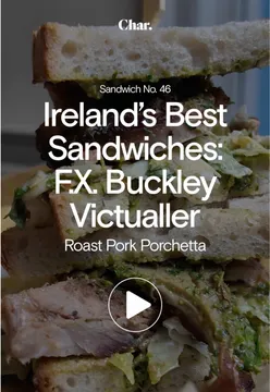 'Diner enjoying a daily gourmet sandwich at F.X. Buckley Victualler in Ireland, featuring roast meats and a charming setup.'