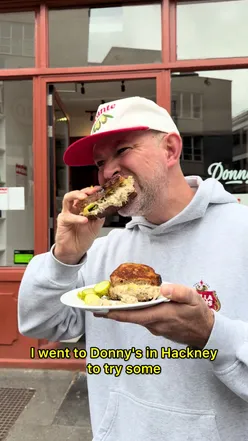 Customers enjoying sandwiches at Donny's in Hackney, surrounded by a cozy atmosphere.