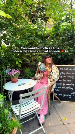 Cozy community garden café in London, perfect for autumn pastries and hot drinks under a glass greenhouse.