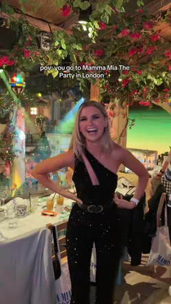 Person in sequins enjoying Mamma Mia! The Party, singing to ABBA in London with travel vibes.