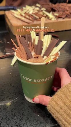 Indulging in rich hot chocolate at Dark Sugars, a female-owned chocolate shop in London, showcasing Ghanaian flavors.