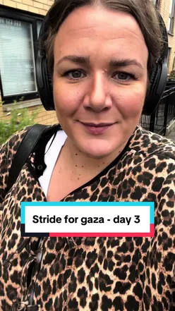 Participants in #strideforgaza25 supporting Palestine with banners and shirts at a fundraising event.