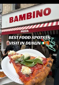 Enjoying New York-style pizza at Bambino in Dublin, featuring Sausage & Peppers and The Vito slices.