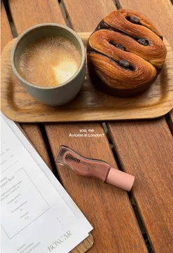 Cozy cafe in London showcasing autumn vibes with fall leaves and warm drinks.