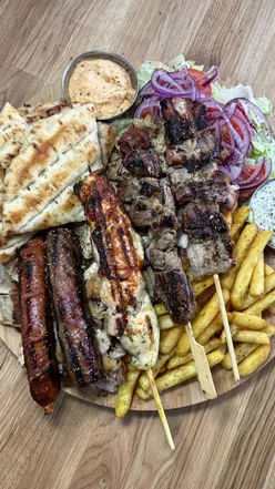 Delicious mixed grill and gyros at the new Greek & Famous restaurant in Cheadle, showcasing authentic Greek cuisine.