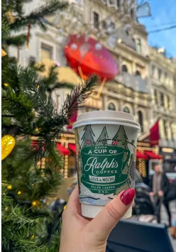 Customers enjoying festive drinks at Ralph's Coffee, Bond Street, London during the holiday season.